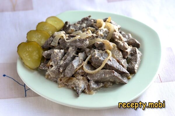 Pork liver in sour cream in a skillet