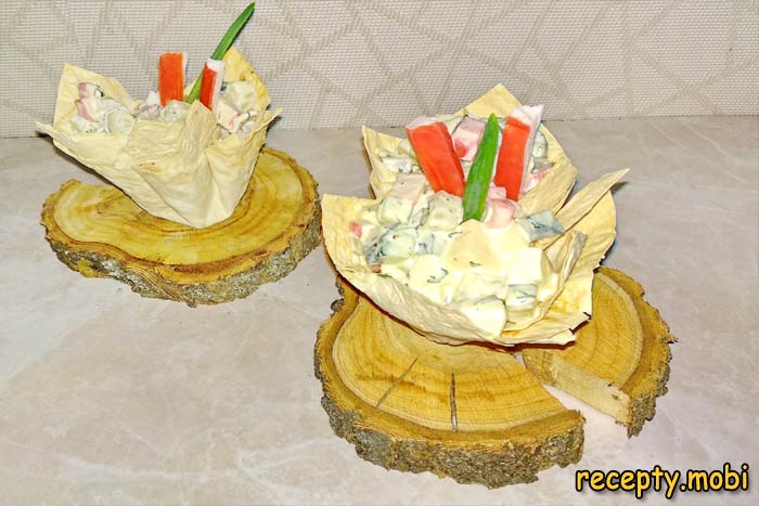 Crab stick salad with pineapple in baskets