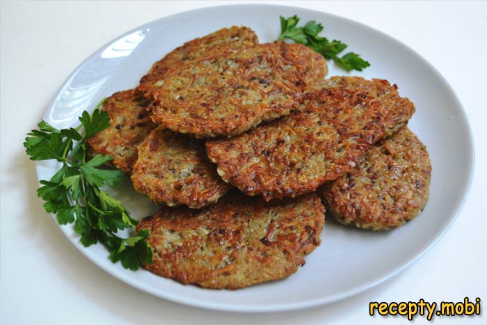Potato pancakes with mushrooms in a pan